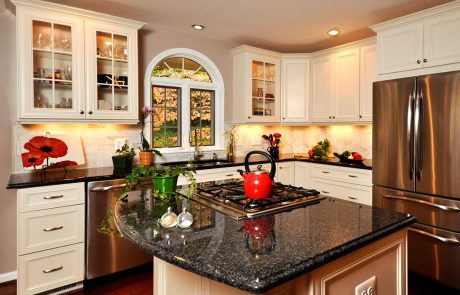 modern white farmhouse kitchen with black countertops