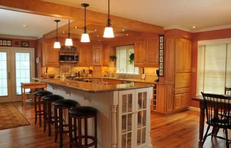 black barstools lined up at a white kitchen island