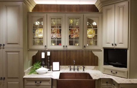 deep country sink installed in a kitchen with cream colored cabinets