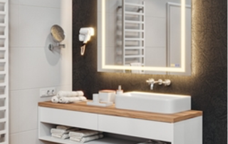 wall-mounted bathroom vanity with a lit mirror above