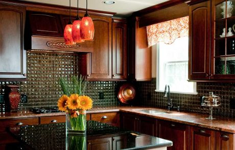 dark wood kitchen cabinets with orange flowers in a vase on an island countertop