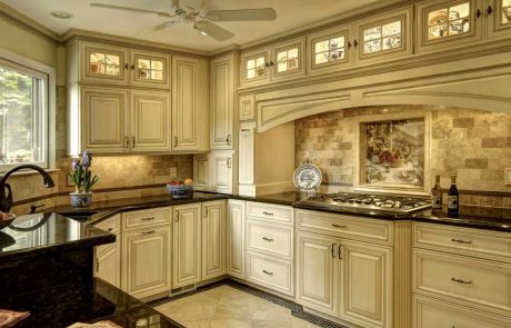 kitchen with cream-colored cabinets and black countertops