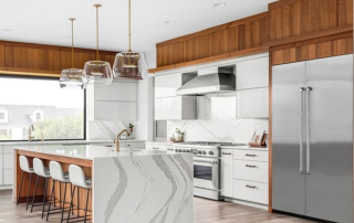 kitchen with marble-sided island and barstools