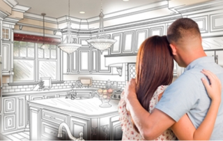 a couple stands together, facing away fromthe camera, looking at an illustration of their dream kitchen