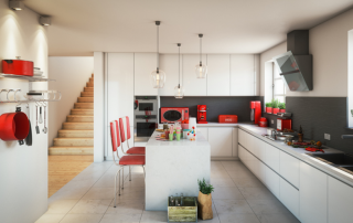 white kitchen with several accents in red, including small appliances, towels, and chairs